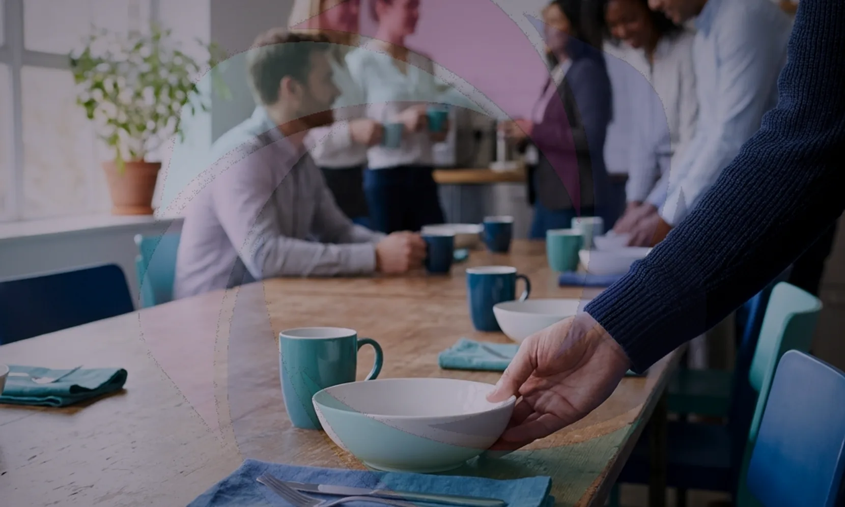 Manager inviting a quieter colleague to speak in a small UK office meeting, illustrating inclusive culture in practice